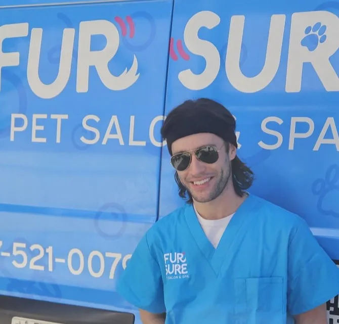 Professional dog groomer Jacob with the Fur Sure mobile dog grooming van in Denver Metro